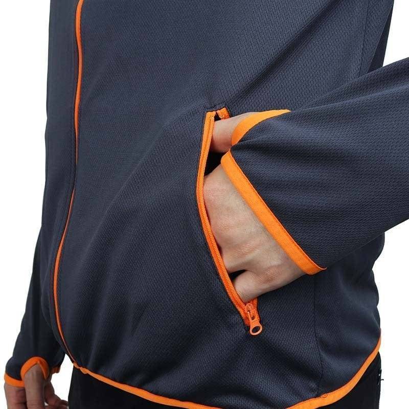 A man wears a windproof, water-repellent outdoor jacket while hiking; essential all-weather activewear.