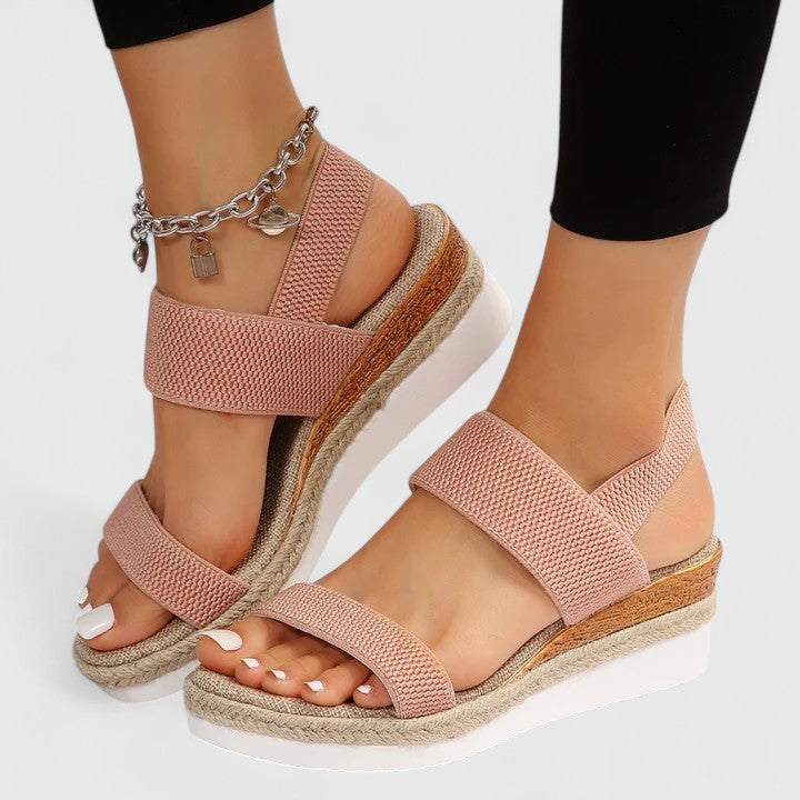 Woman's feet wearing supportive orthopedic wedge sandals, emphasizing comfort and proper fit.