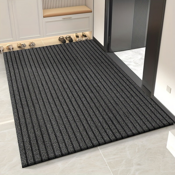 Durable grey weatherproof doormat, perfect for indoor or outdoor use, effectively traps dirt & mud at your entryway.