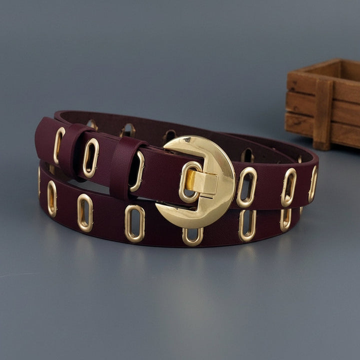 Vibrant purple women's belt, a stylish accessory with an eye-catching hollow out design and shiny metal details.