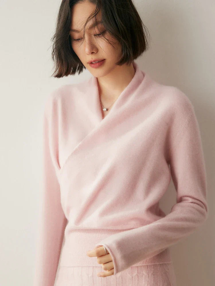 Woman wearing a luxurious pink cashmere crossover sweater, cozy knitwear