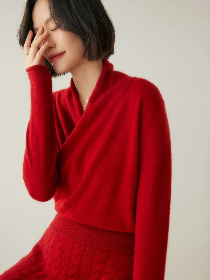 Woman wearing a luxurious ivory cashmere crossover sweater, warm knitwear
