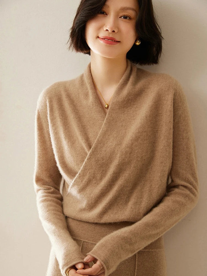 Woman posing in a chic ivory cashmere crossover sweater, premium knit