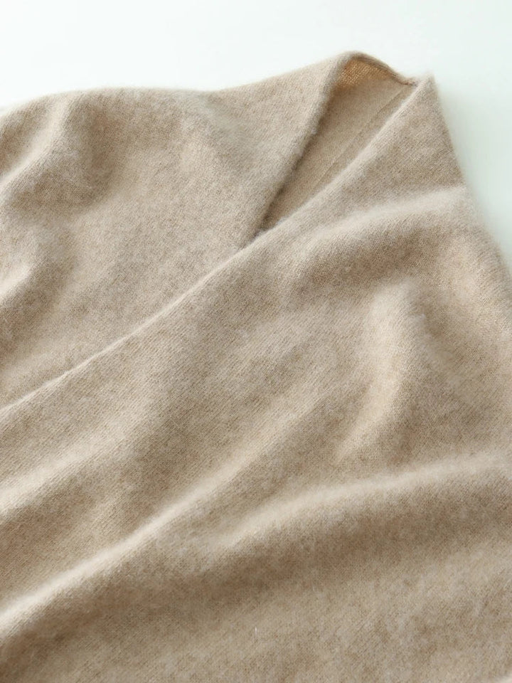 Close-up of a luxurious camel cashmere crossover sweater, rich hue
