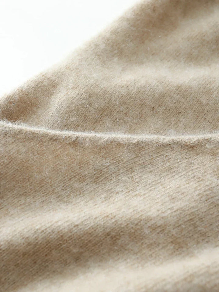 Woman posing in a warm camel cashmere crossover sweater, premium knit