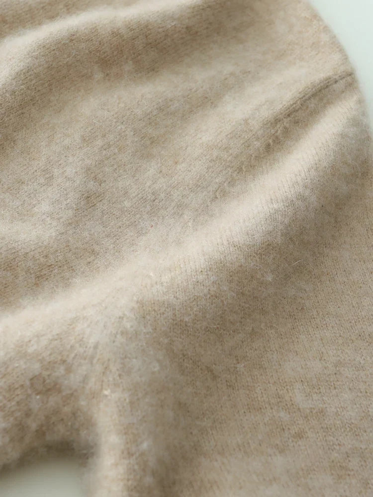 Woman wearing a luxurious beige cashmere crossover sweater, soft knitwear