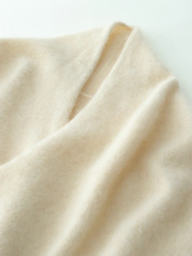 Close-up of a luxurious beige cashmere crossover sweater, gentle color