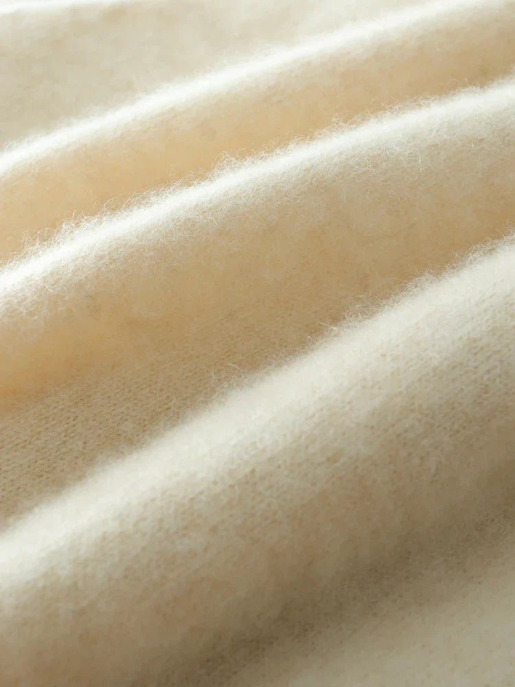 Back view of a woman in a beige cashmere crossover sweater, casual chic