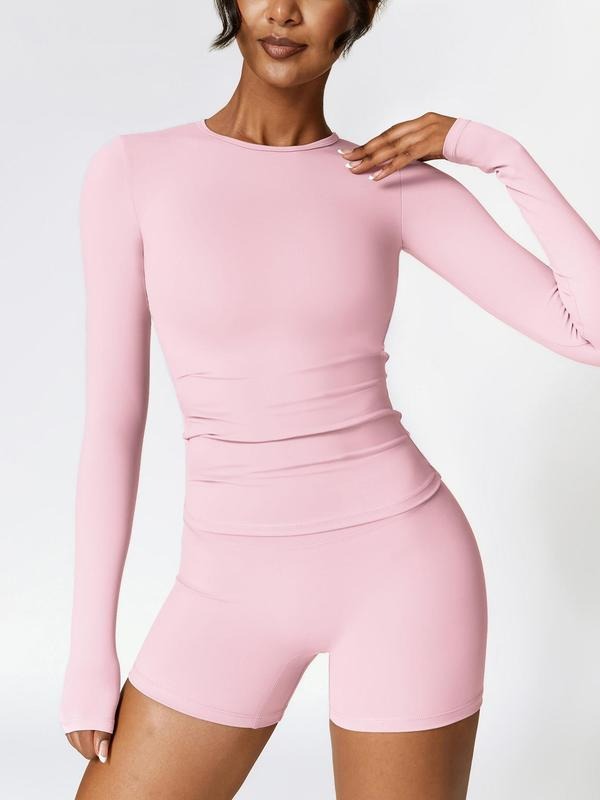 Athleisure women's black activewear set, perfect for workouts, includes a crop top and fitness shorts.