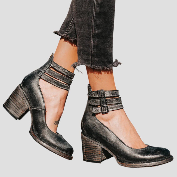 Women's black block heels with closed toe & chic buckle strap. Elegant & comfortable work or formal shoes.