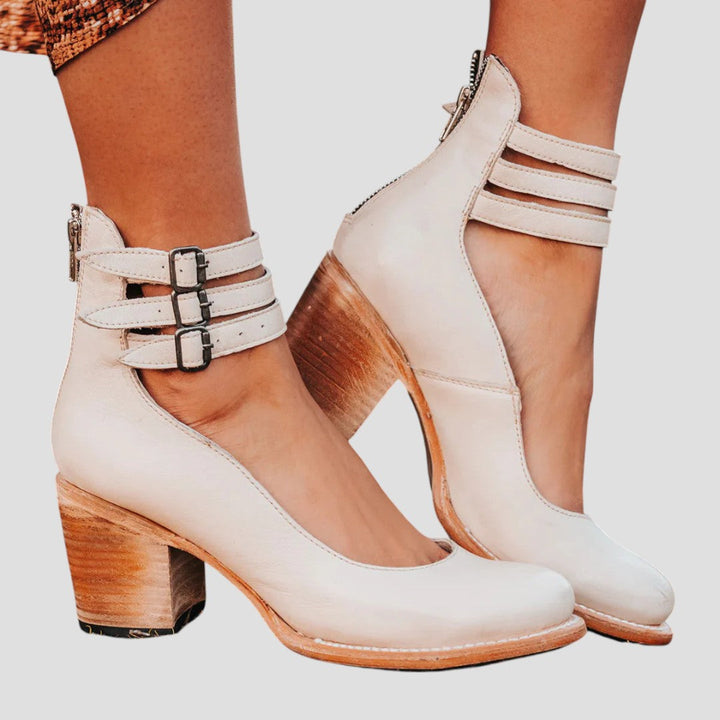 Elegant black block heels for women, featuring a stylish closed toe and adjustable buckle strap.