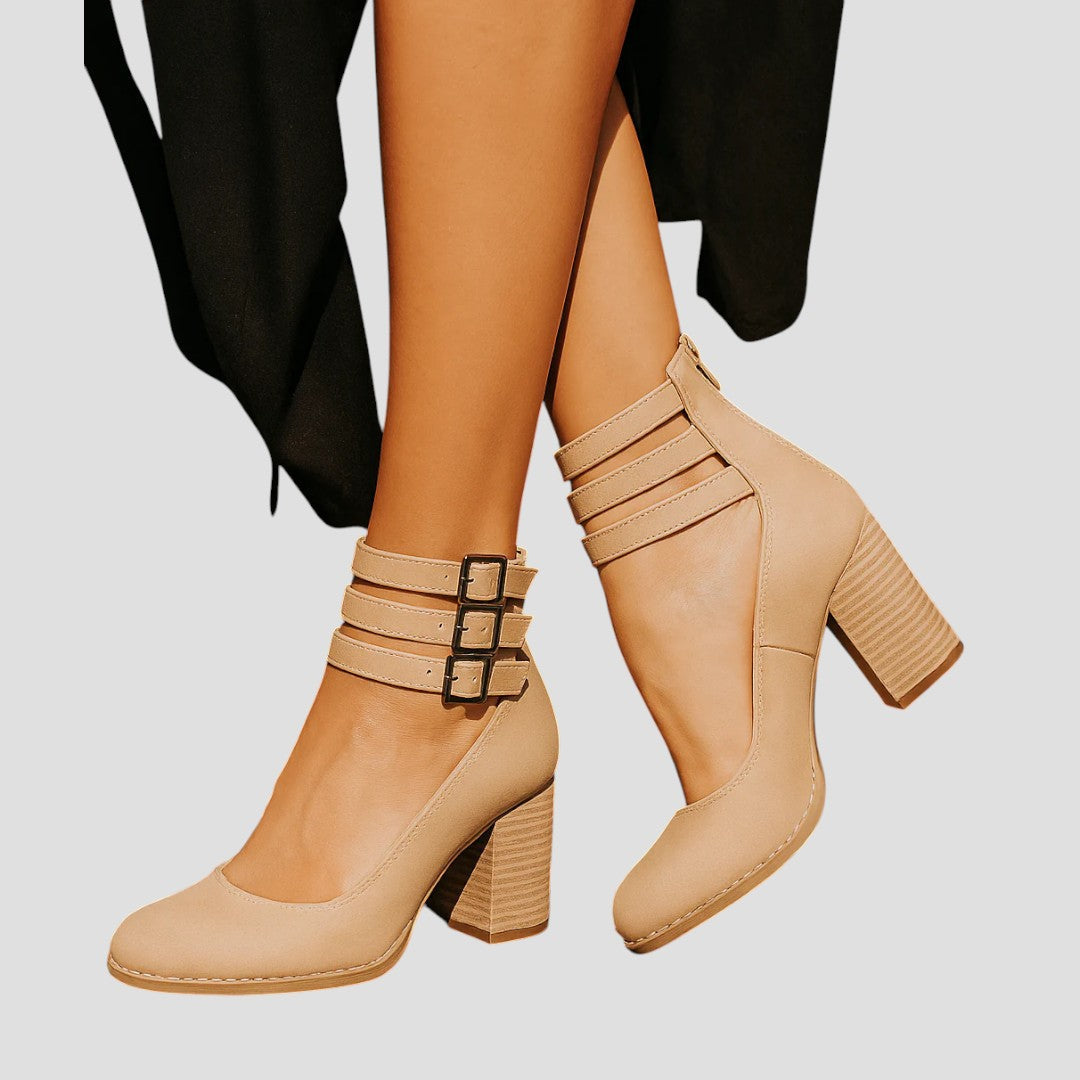 Modern women's block heels with a closed toe and chic buckle strap. Elegant, comfortable, versatile footwear.