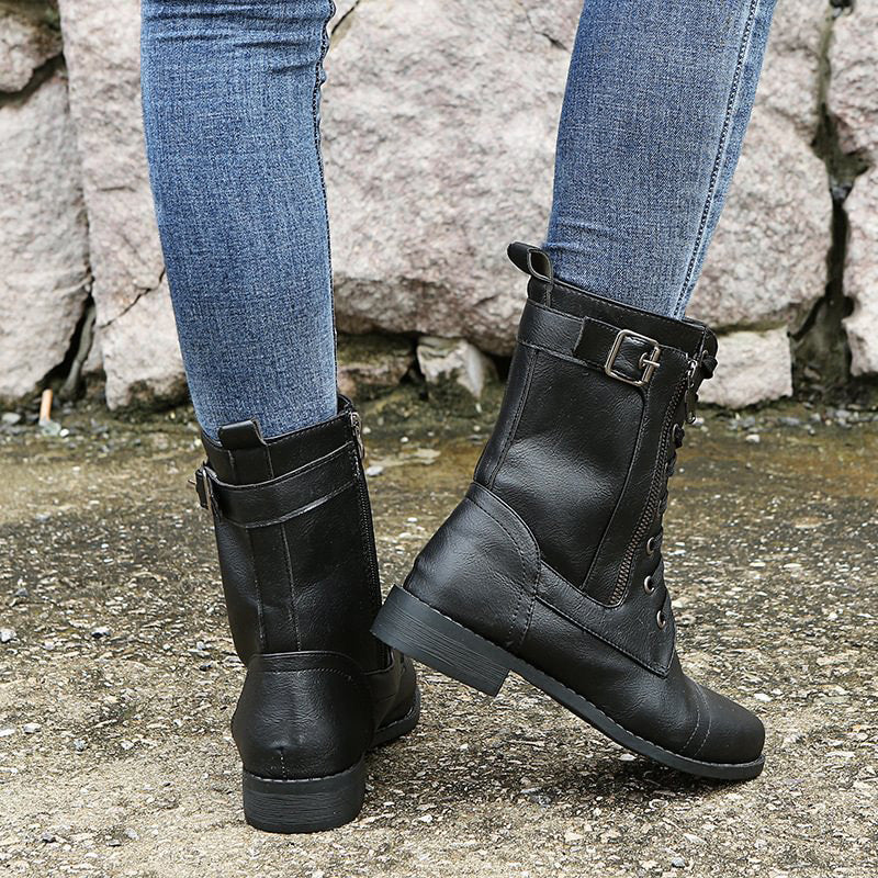 Stylized shot of women's combat boots against a textured background, highlighting their rugged charm.