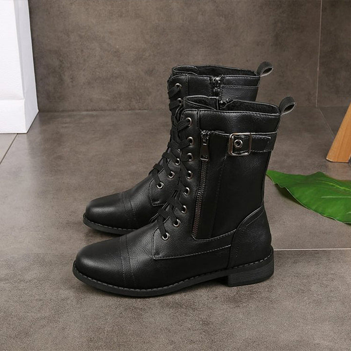 Side profile of women's black combat boots, featuring the side zipper and sturdy construction.