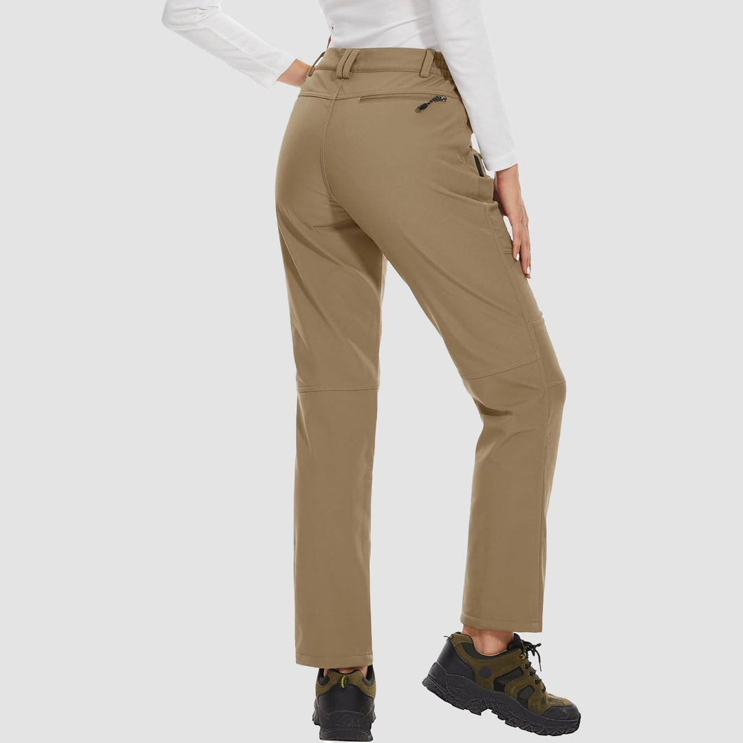 Collection of women's ski pants: black, grey, and blue softshell with fleece lining