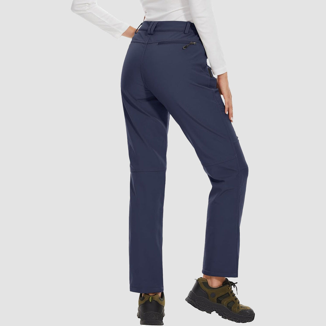 Elegant women's purple softshell ski pants, fleece-lined for warmth on the slopes