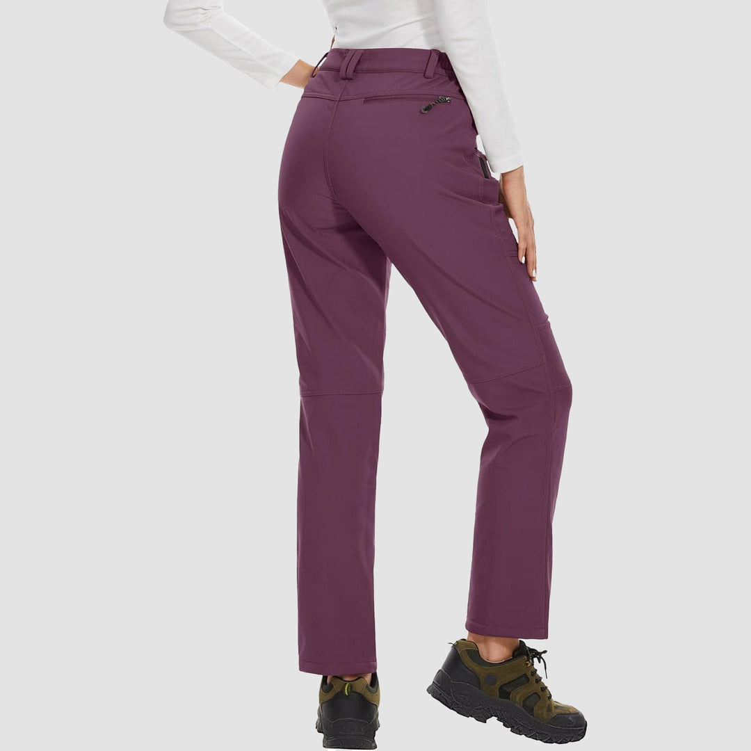 Women's outdoor softshell pants in a vibrant blue, fleece-lined for winter activities