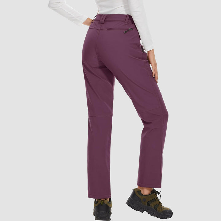 Women's outdoor softshell pants in a vibrant blue, fleece-lined for winter activities