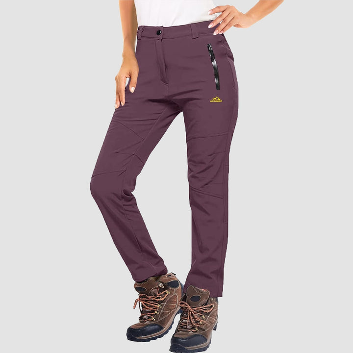 Model wearing women's waterproof black ski pants, designed for athletic outdoor activities