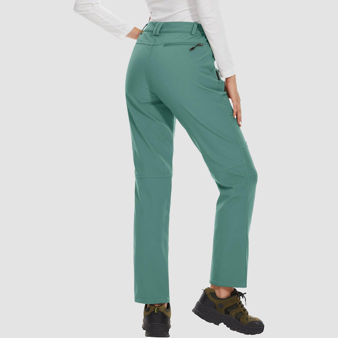 Women's protective black softshell pants with fleece lining, ideal for cold weather hiking