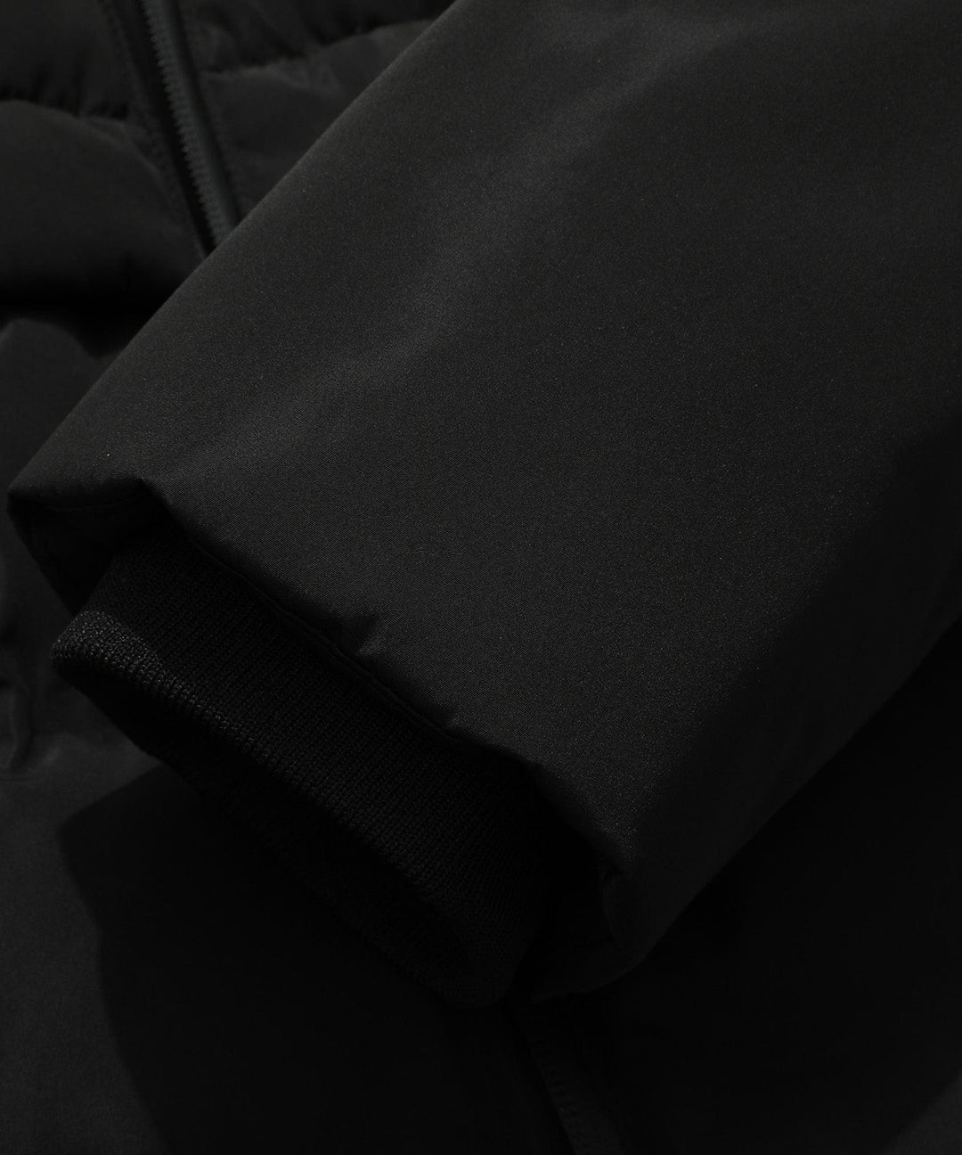 Cozy insulated women's black parka with hood, protecting against cold weather conditions.