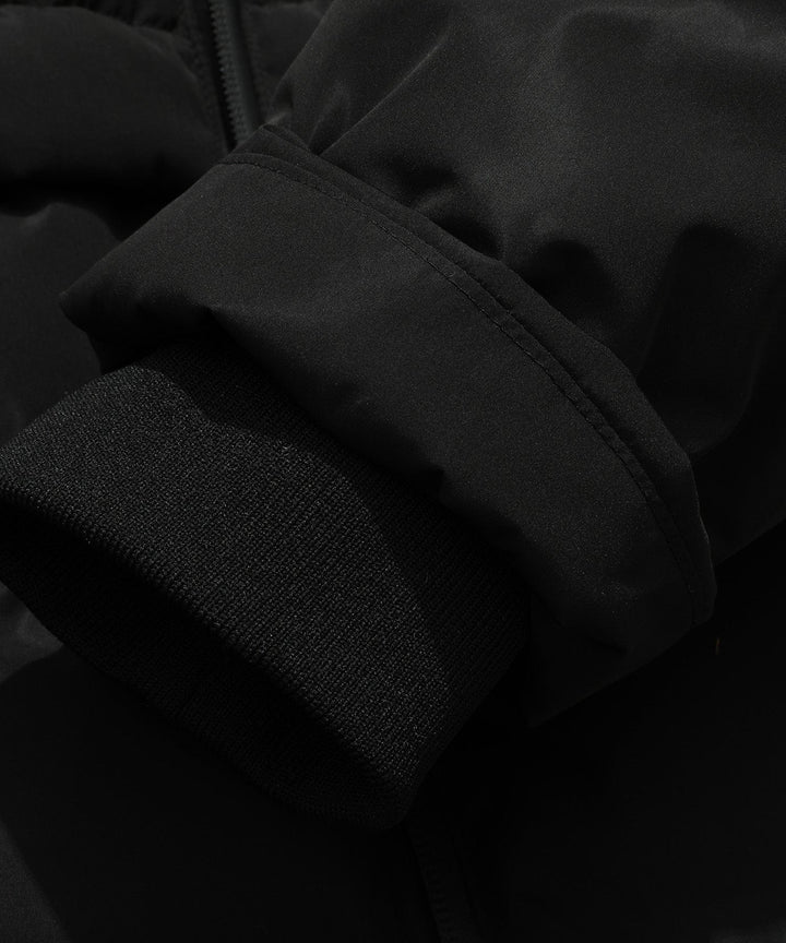 Inside view of pockets and lining of a women's black insulated parka jacket, practical winter wear.