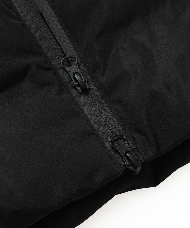Detail of the warm hood with faux fur trim on a women's insulated black long parka coat.