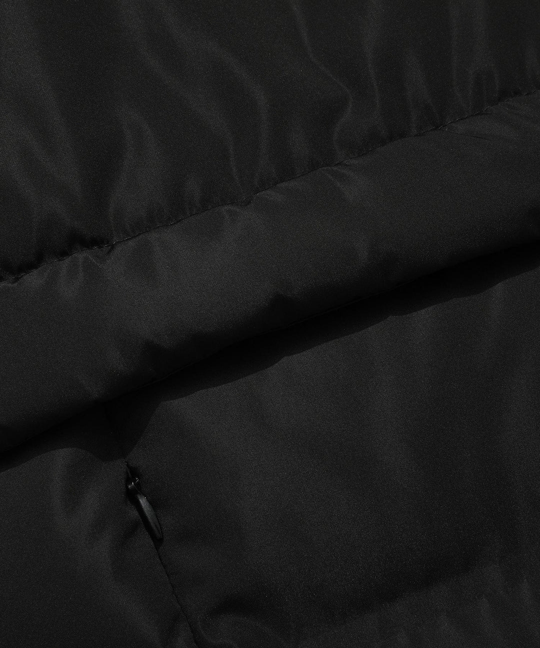 Back view of a women's insulated black parka, showcasing its length and winter readiness.