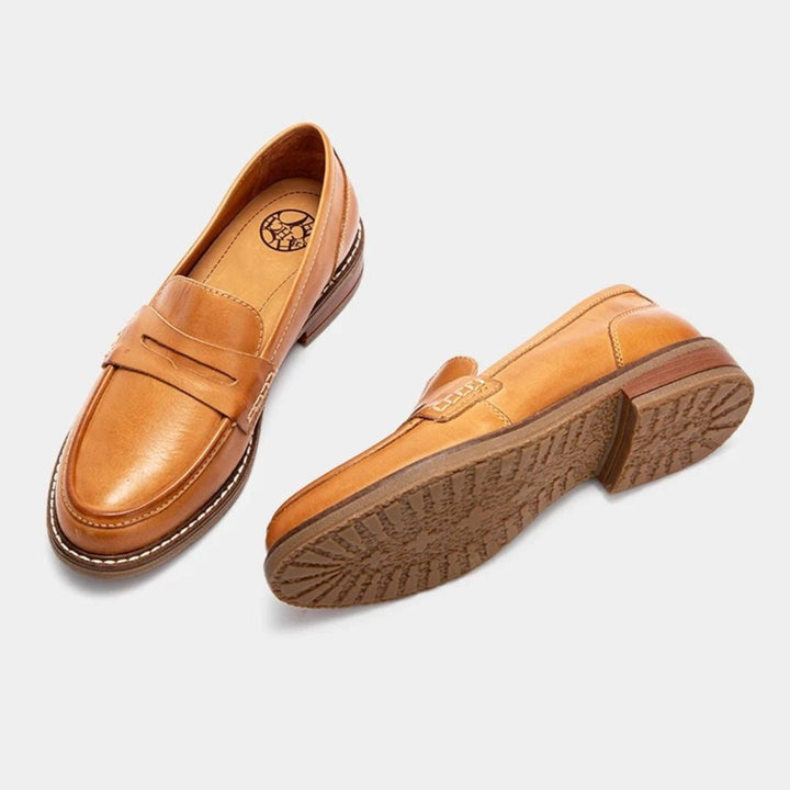 Side view of women's leather loafers showing the ergonomic sole and classic design
