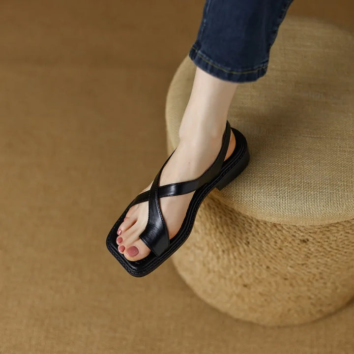 Women's flat leather sandals with adjustable cross straps, designed for all-day comfort