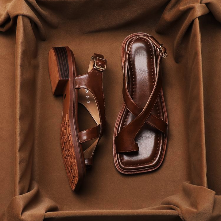 Side view of women's flat leather sandals with a double cross strap, perfect for casual wear