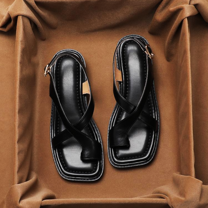 Overhead view of women's leather flat sandals with a stylish cross strap design