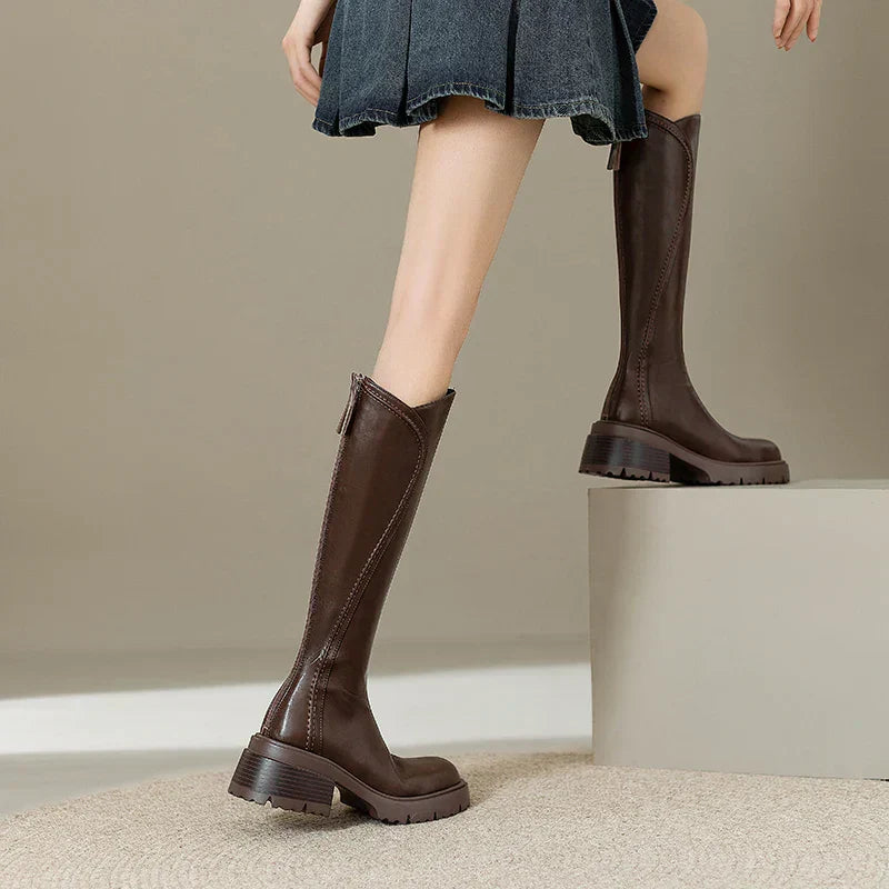 Lady wearing women's orthopedic brown leather knee-high boots, outdoor setting, fall style