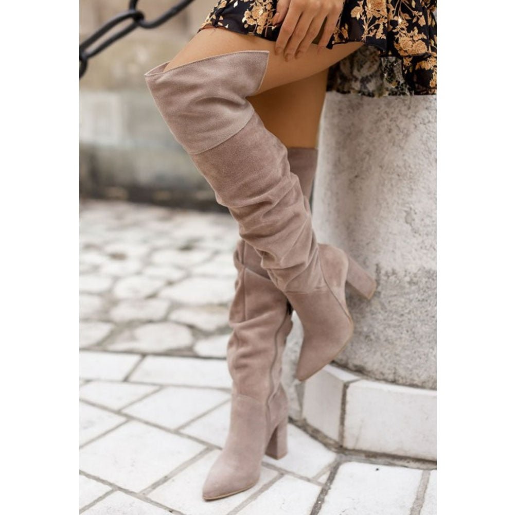 Fashionable women's slouchy over-the-knee boots with a high block heel, perfect for winter outfits.