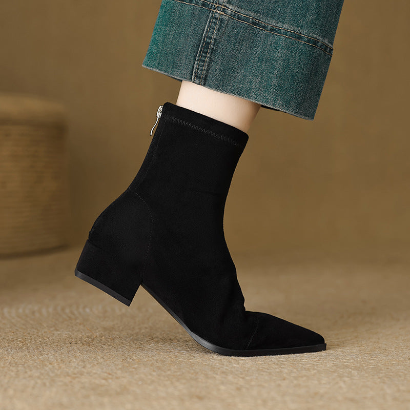 Close-up of a women's block heel sock boot, highlighting the pointed toe and textured material