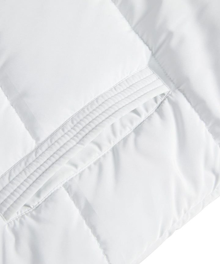 Fashionable women's longline puffer vest with diamond quilting, suitable for outerwear.