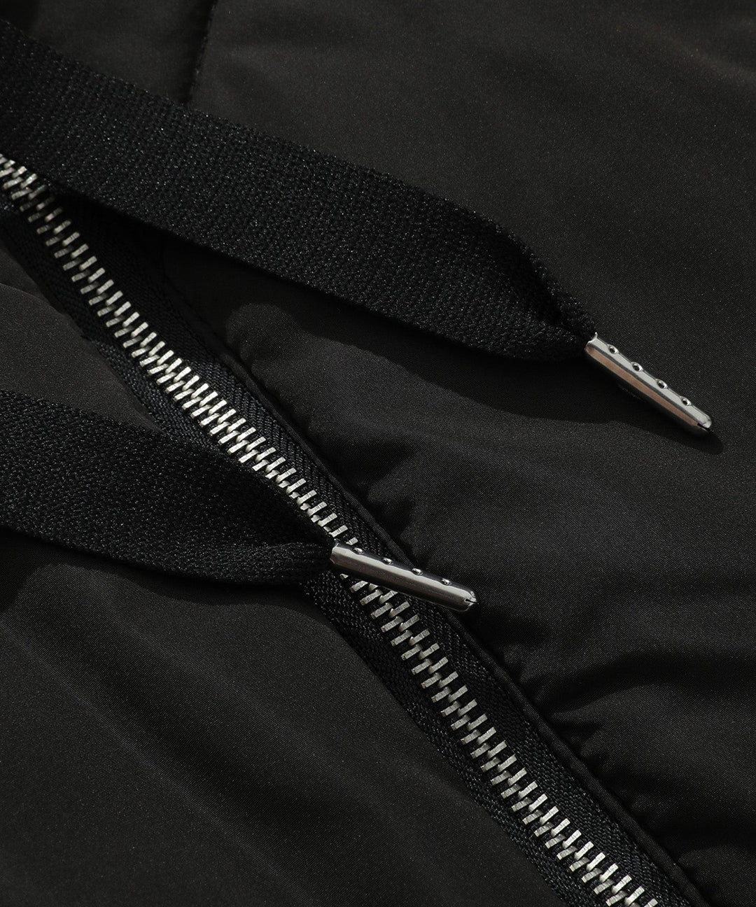 Detail of the zipper and pockets on a women's practical quilted hooded puffer vest