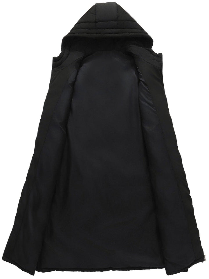 Woman wearing a navy blue quilted puffer vest with hood over a long-sleeved shirt