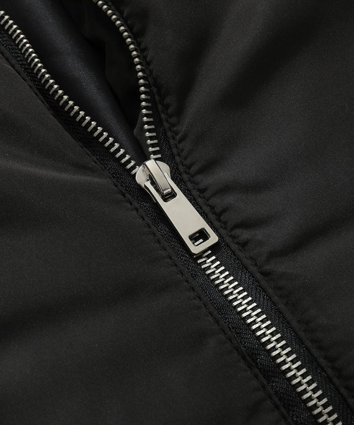 Back view of a women's black quilted puffer vest with a well-fitted hood, winter fashion