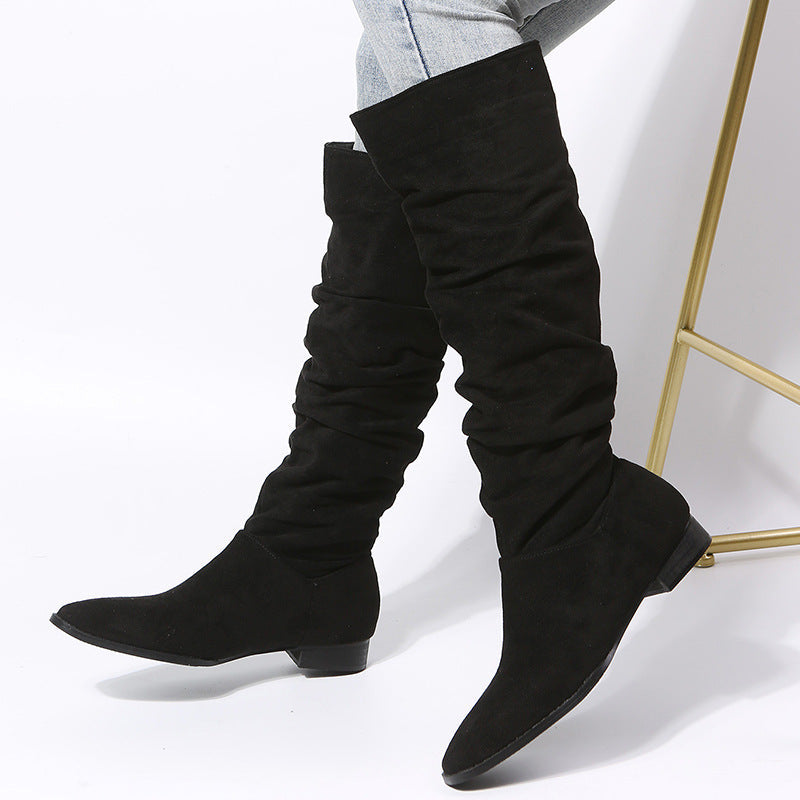 Women's black slouchy knee-high boots with a comfortable block heel, perfect for fall and winter fashion.