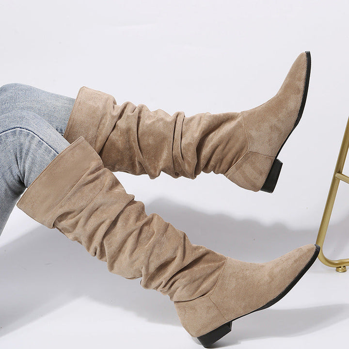 Close-up of a women's slouchy knee-high boot, highlighting the soft material and stable block heel.