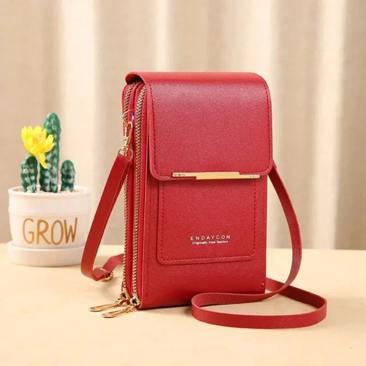 Elegant ladies' faux leather crossbody bag with touch screen pocket for easy phone access.