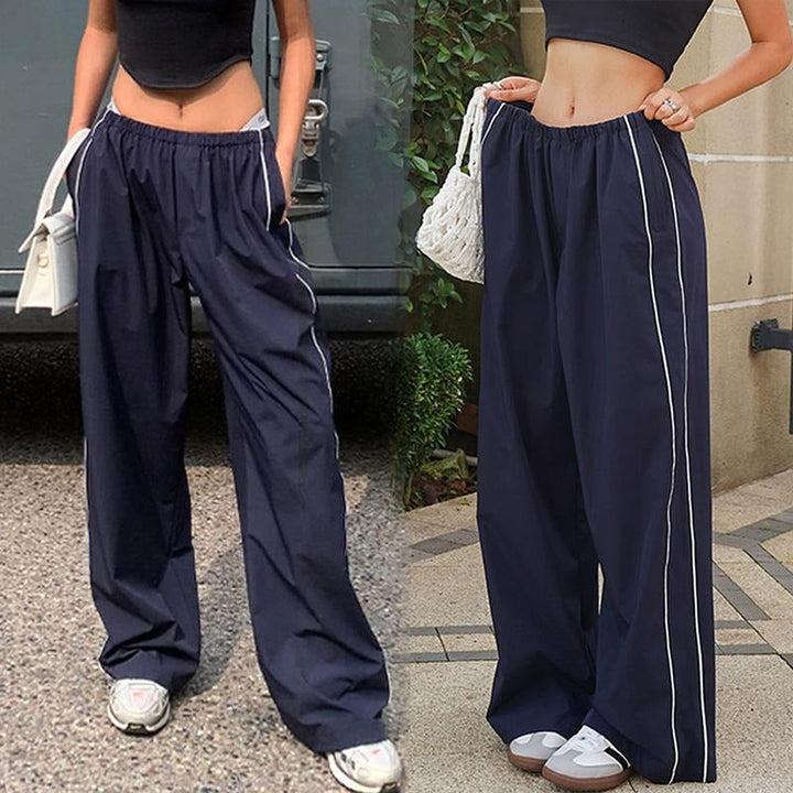 Close-up of women's wide-leg track pants, highlighting the quality polyester and contrast piping.