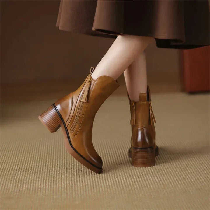 Full shot of women's fashion boots with a block heel and zip closure, a must-have for winter elegance.