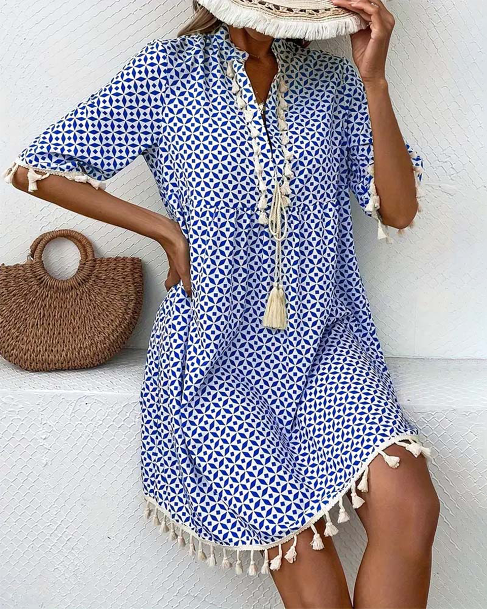Casual V-neck boho mini dress for women, featuring a blue geometric print and tassel details, ideal for beach wear.