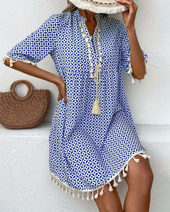 Casual V-neck boho mini dress for women, featuring a blue geometric print and tassel details, ideal for beach wear.