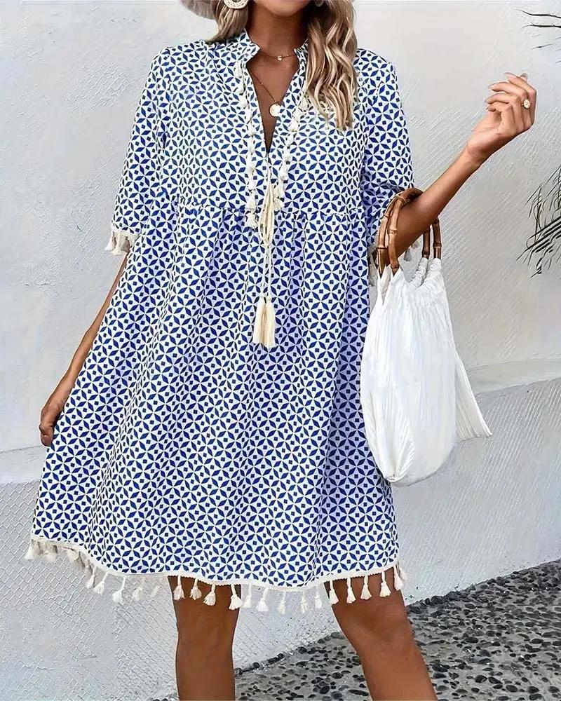 Flowy blue geometric print boho mini dress, V-neck design with tassels, great for women's casual outings.