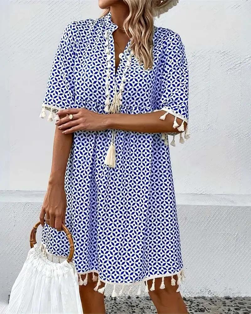 Eye-catching blue boho mini tunic dress for women, showcasing a bold geometric print and fun tassel details.