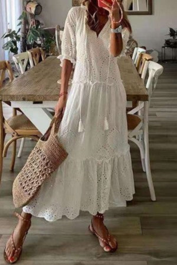 Flowy bohemian women's long floral maxi dress. Features a chic tassel V-neck, ideal for summer fashion & casual wear.
