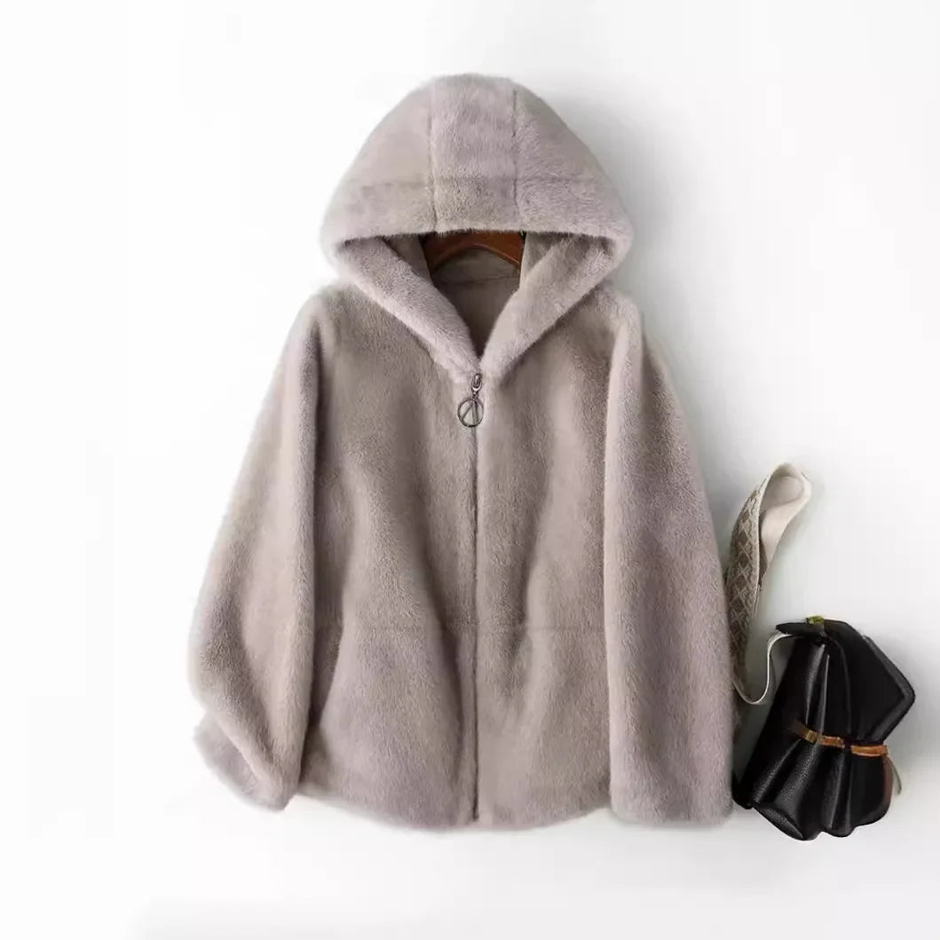Stylish woman wearing a cozy faux fur hooded jacket, perfect for winter and elegant fashion